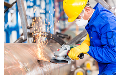 Employee in an Industrial Manufacturing Plant Working on a Pipeline.