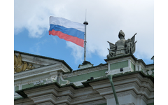 Russian flag flying on a flagpole on top of a building