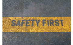 Safety first sign on industrial caution strip