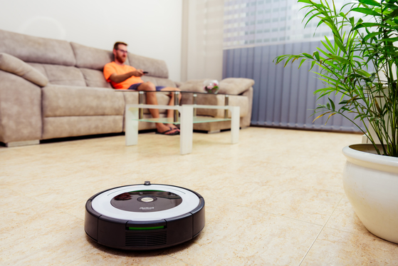 Roomba cleaning living room floor 