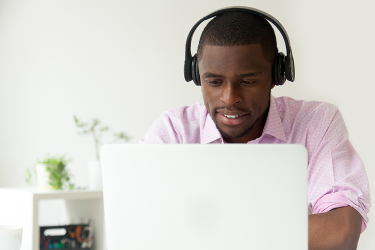Person with headphones on laptop