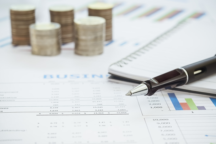 Business diagram on financial report with coins and calculator.