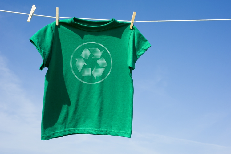 T-Shirt with recycling symbol hanging on line with clothespins.