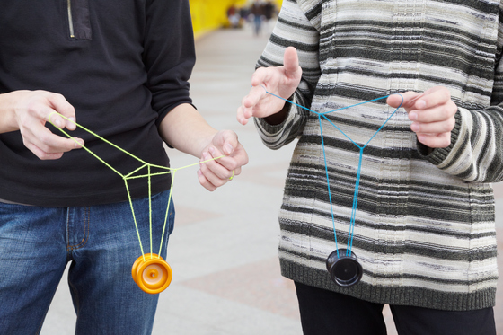 two kids doing a yo-yo trick