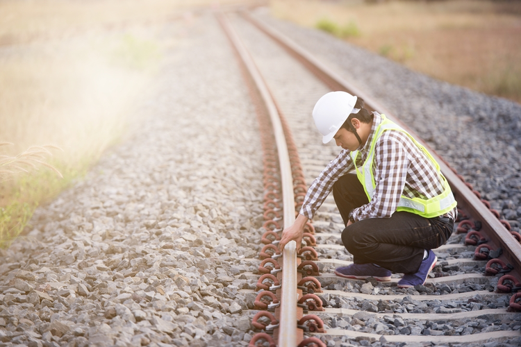 Railroad worker checking railway.