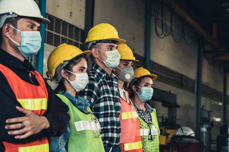 Factory workers wearing protective masks