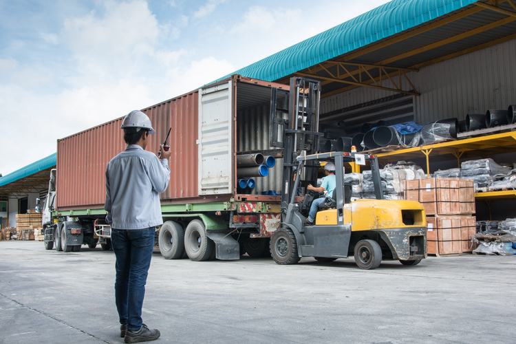 warehouse laborer team at unloading works with forklift loader