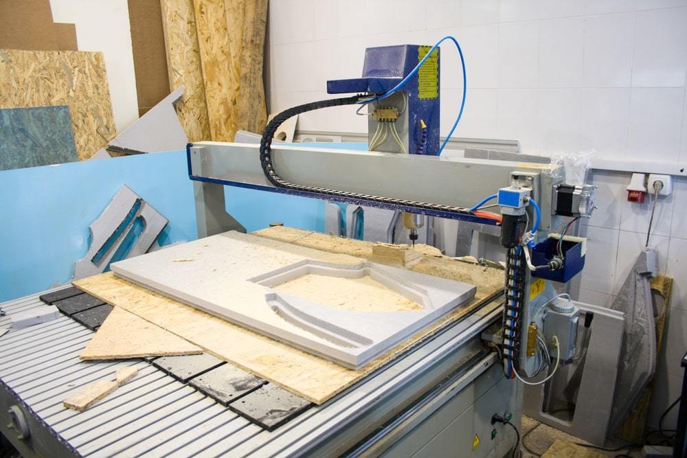 A CNC router cutting shapes in material.