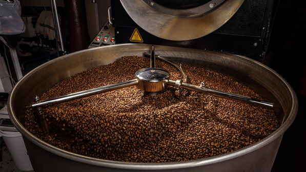 Coffee roasters stir the beans while they roast to ensure even temperatures.
