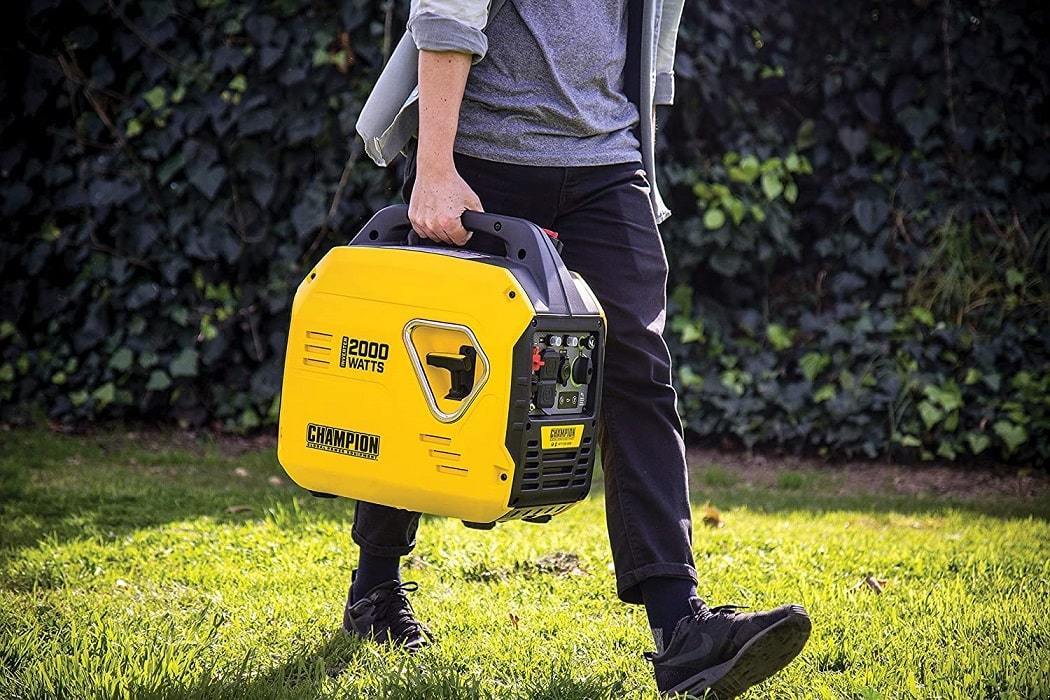 A person carrying a portable inverter generator