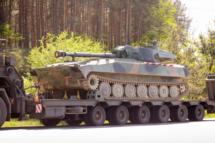 camouflage military semis and trailers carrying tanks images facing sideways