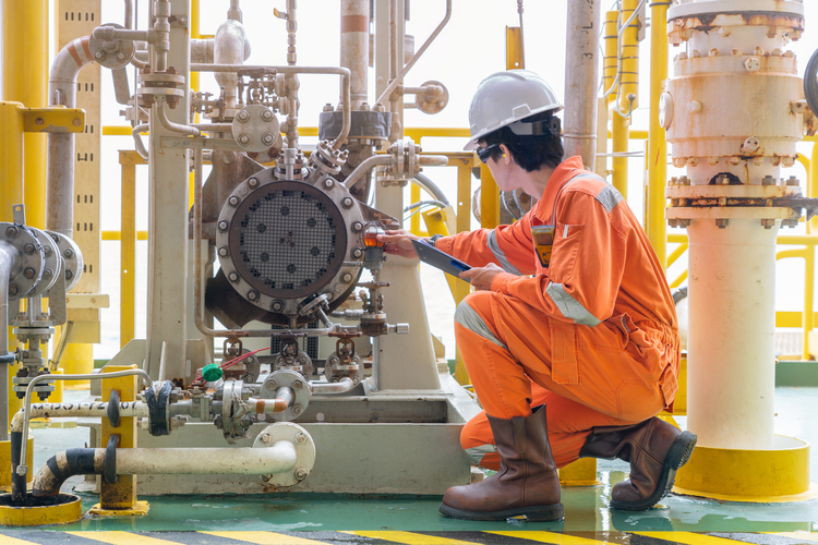 Mechanical engineer inspects a crude oil pump.