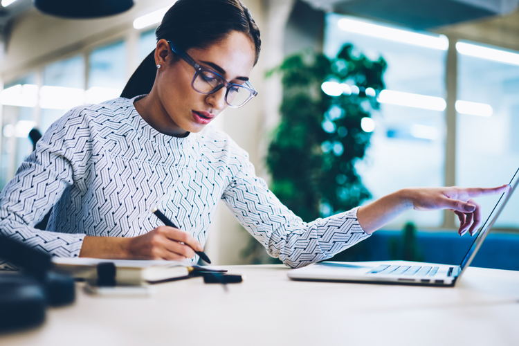 Businesswoman working on business plans using a laptop