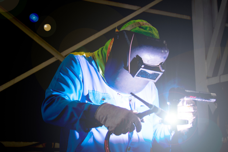 Welder working on the machine floor