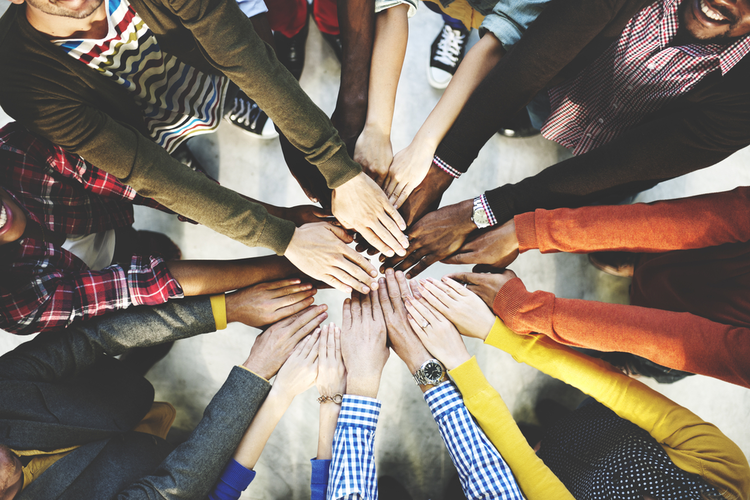 Group of diverse hands coming together
