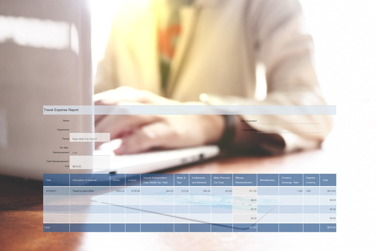 Man using laptop to complete travel expense report