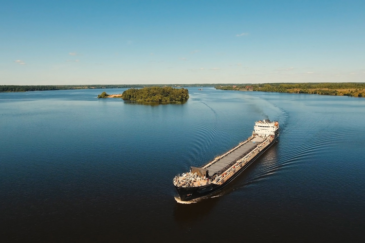 Barge with cargo moving down a river