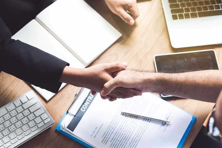 Professionals shaking hands over contract