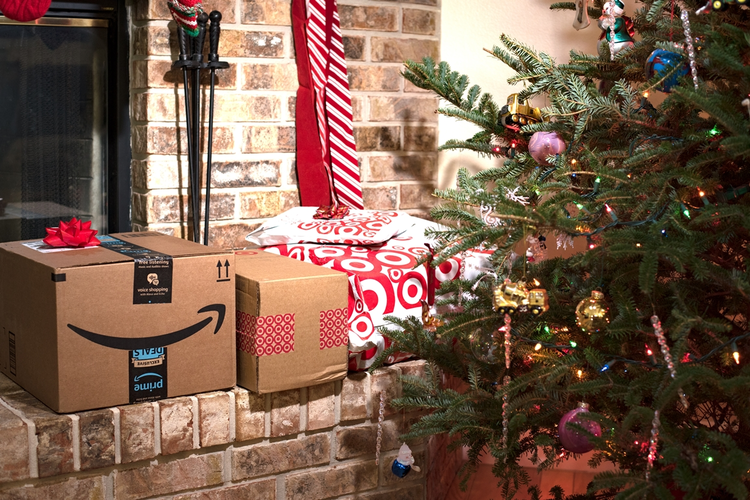 Amazon Prime and Target boxes by fireplace next to Christmas tree