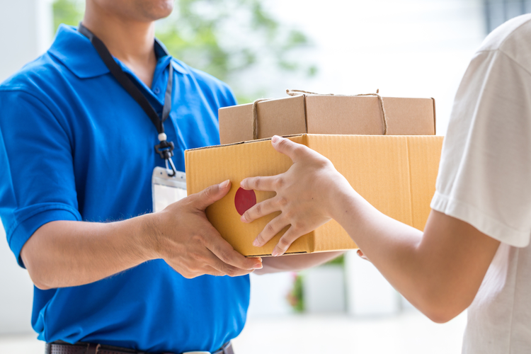 Delivery worker handing packages to customer