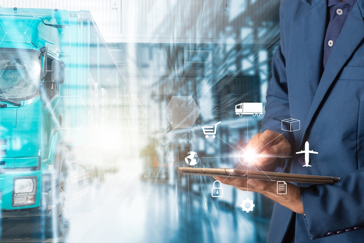 Businessman using tablet to complete supply chain tasks using smart technology