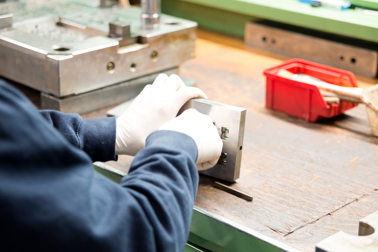 Worker creating manufacturing mold