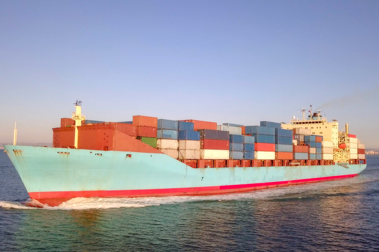 Freight ship in the ocean carrying cargo in shipping containers