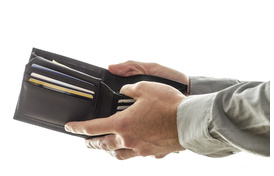 Man opening his wallet to pay for something.