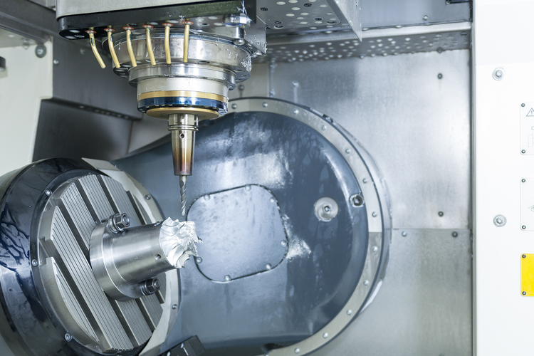 Five-axis Computer Numerical Control (CNC) machine cutting aerospace parts.