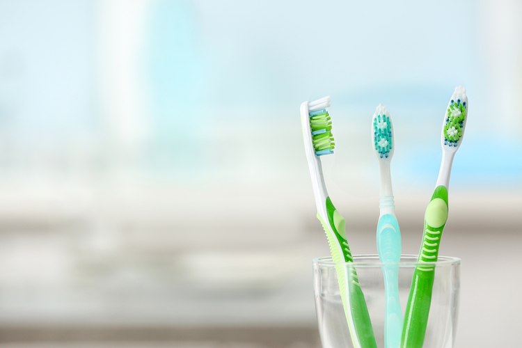 Toothbrushes sitting in a glass