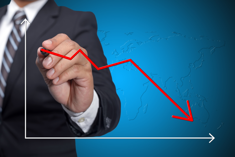 Business man drawing decline graph over blue background.