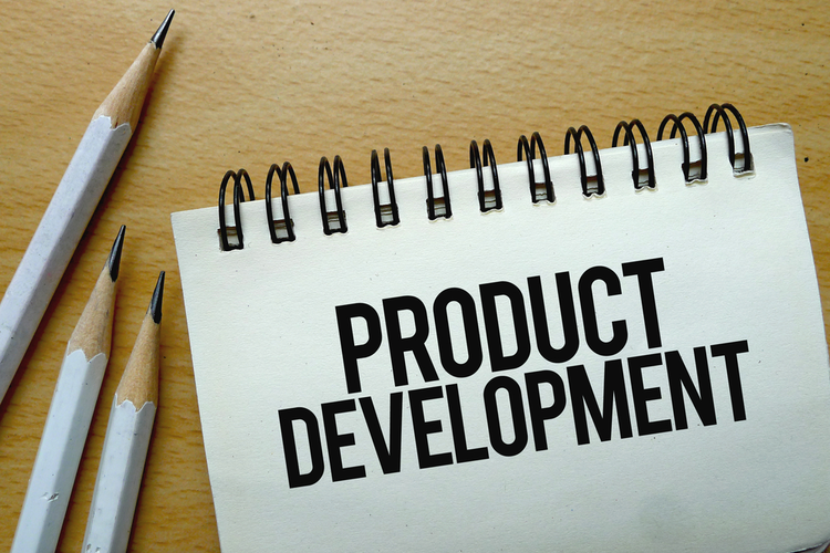 Product Development on notepad with pencils.