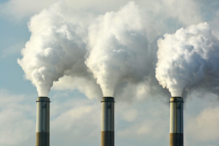 Coal fossil fuel power plant smokestacks emitting carbon dioxide pollution.