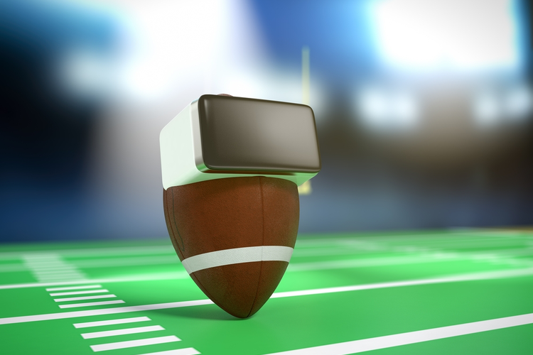 Football with virtual reality glasses at a stadium.