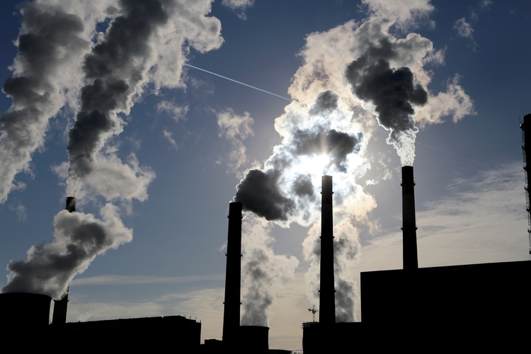 Smoke stacks at a fossil fuel plant.