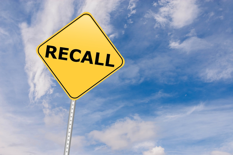 Recall road sign against the sky.