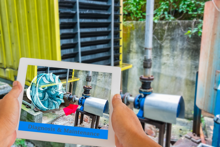 Industrial 4.0 augmented reality concept: Hand holding tablet with AR maintenance application.