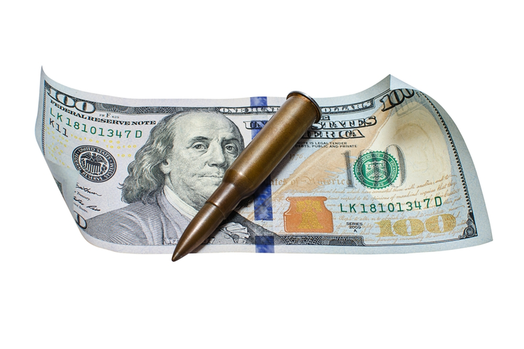 Gun cartridge on a 100 dollar bill.
