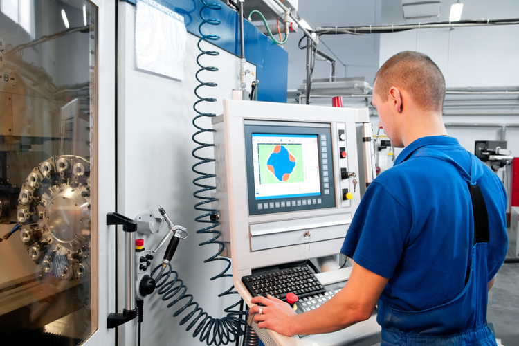 Man operating a CNC machine.