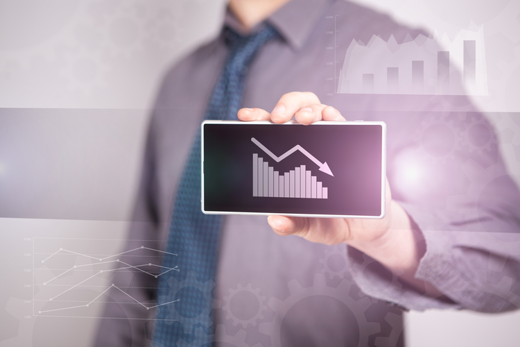 Smart phone with graph indicating declining sales