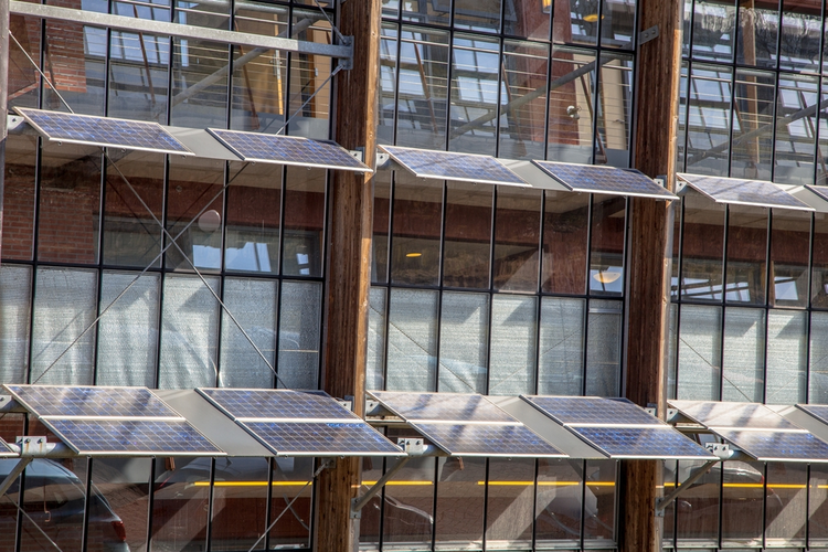 Solar panels on the front of an office building.