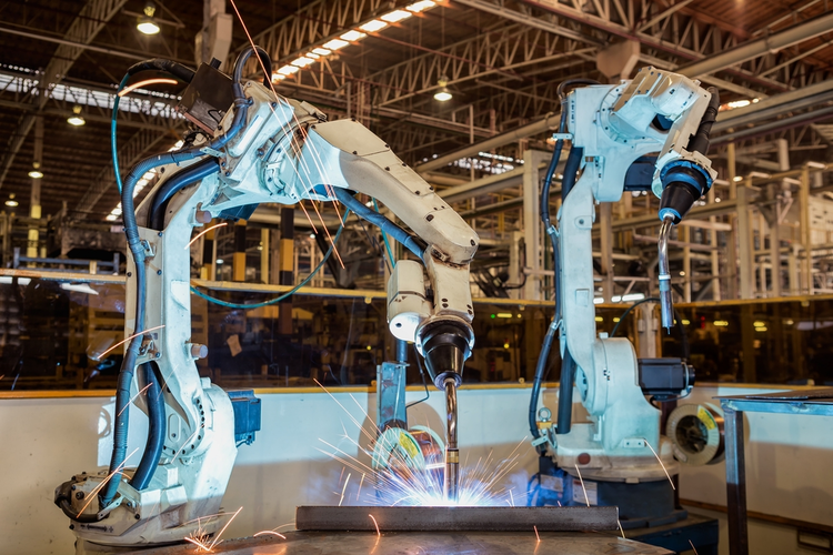 Industrial robots welding in an automotive factory.