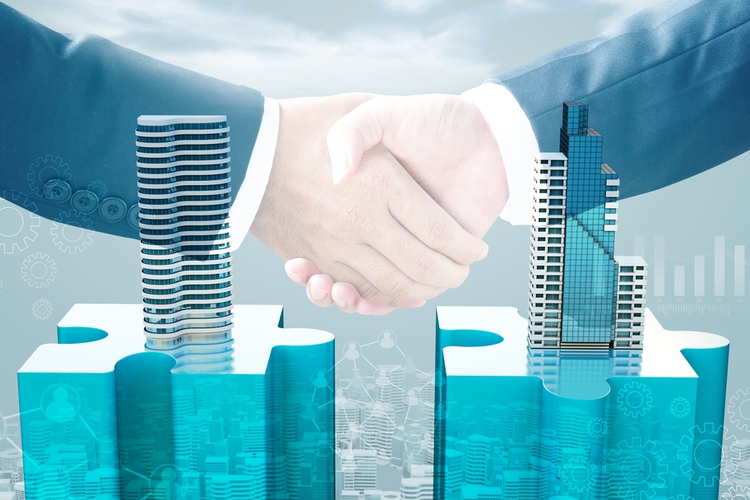 Merger and acquisition business concept: Puzzle pieces with buildings and handshake.