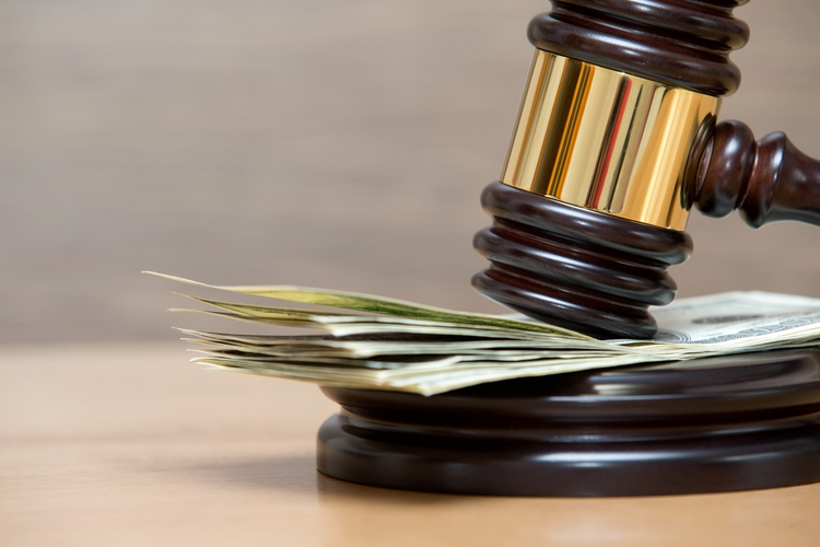 Gavel on top of money.