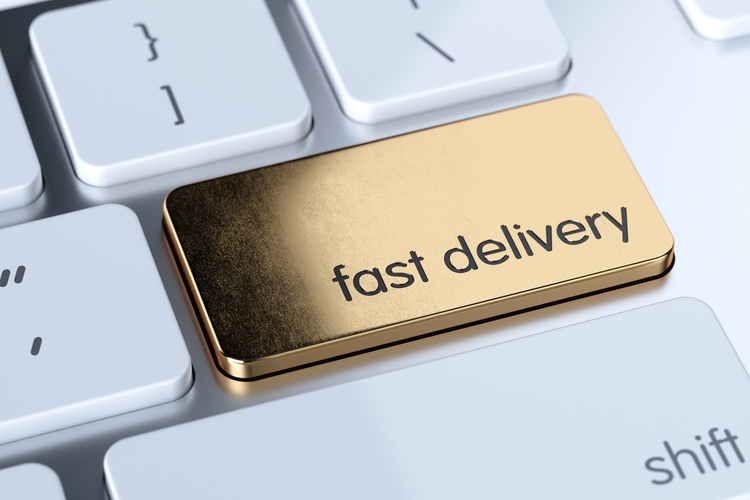 Golden fast delivery sign button on white computer keyboard.