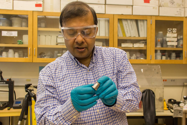 Amit Bandyopadhyay displays 3D printed bimetallic sample.