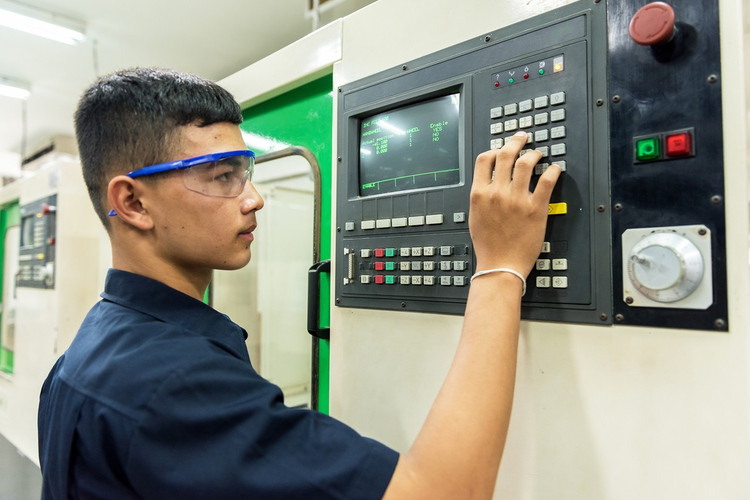 CNC machine and operator.