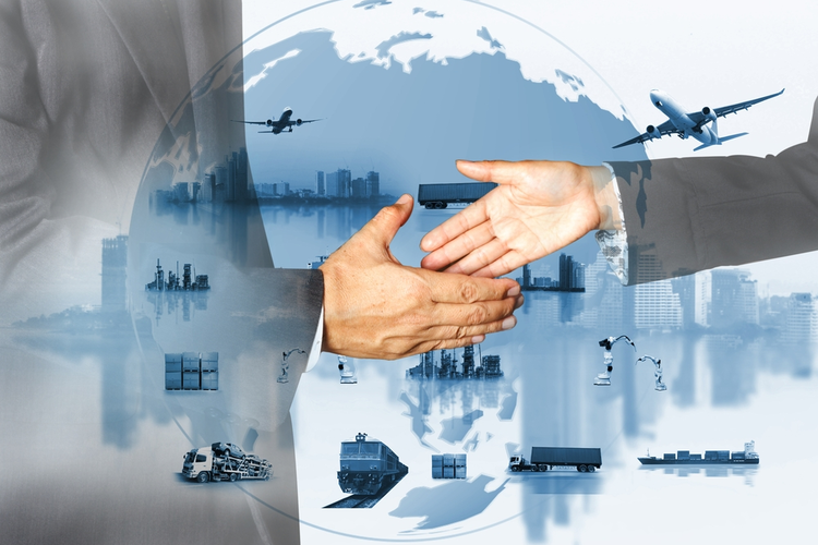 Business professionals shaking hands in front of supply chain concept.