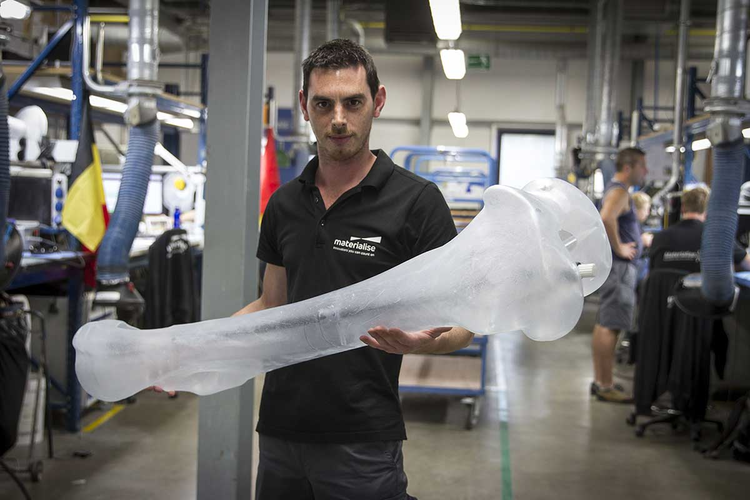 Materialise employee holding a 3D-printed mammoth bone.