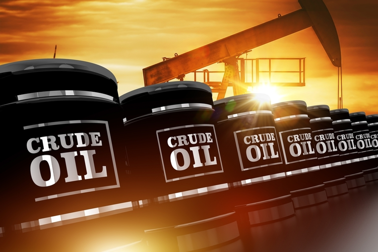 Crude oil trading concept with black crude oil barrels and oil pump during sunset.
